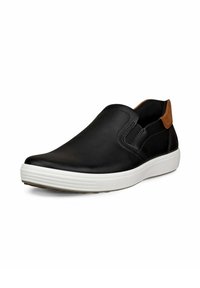 Schwarze Leder-Schlupfschuhe mit elastischen Seitenpaneelen, einem braunen Akzent an der Ferse und einer weißem Gummisohle mit strukturierten Details.