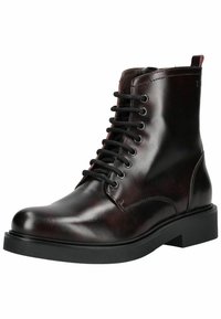 Bottine à lacets en cuir brun foncé avec semelle noire et bout rond, montrant le profil droit sur fond blanc.