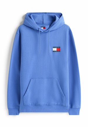 Sudadera con capucha de color azul claro, con bolsillo frontal y parche del logo de Tommy Jeans en el lado izquierdo del pecho.