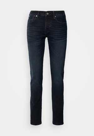 Dunkelblaue Denim-Jeans mit geradem Bein, Fünf-Taschen-Design und sichtbaren Nähten; ausgestattet mit einem Reißverschluss und einem Knopfverschluss.