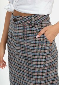 Wollmischung Rock mit einem karierten Muster in Grau, Blau, Pink und Schwarz. Mit hoher Taille, Knopfverschluss und Seitentaschen.