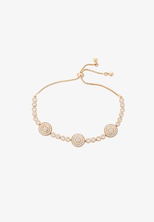 Bracciale intonato all'oro con accenti circolari decorati da gemme trasparenti, uniti da una delicata catena, regolabile con una chiusura scorrevole.