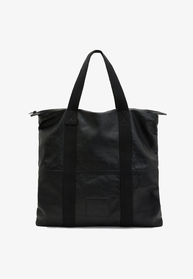 Sac fourre-tout en cuir noir avec de larges anses en tissu, fermeture éclair et logo patch à l'avant.