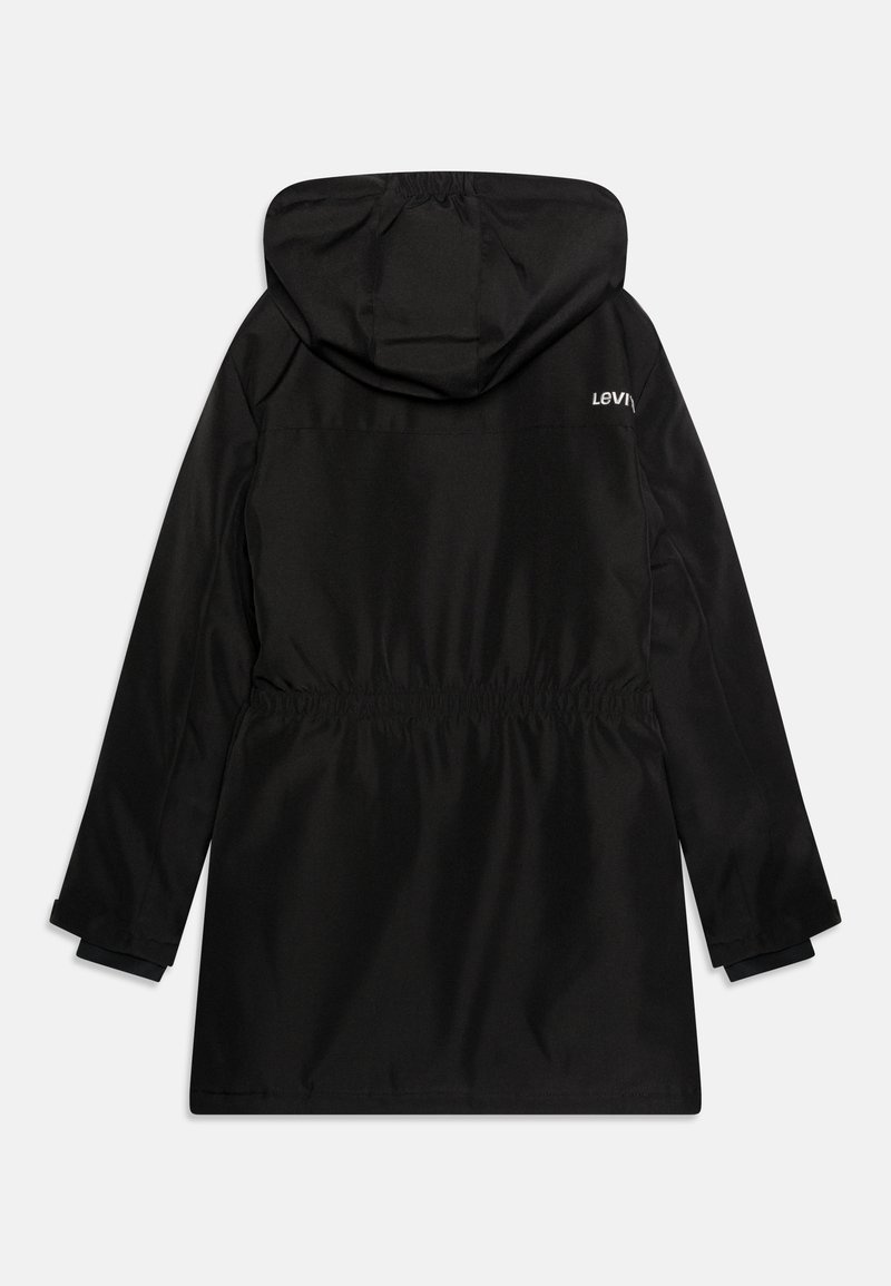 Parka noire imperméable avec capuche, taille élastique et logo Levi's dans le haut du dos. Manches longues avec poignets ajustables. Texture lisse.