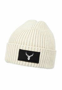 Cream knit beanie with a ribbed texture. Features a black rectangular patch with a white deer graphic. Soft, warm material.