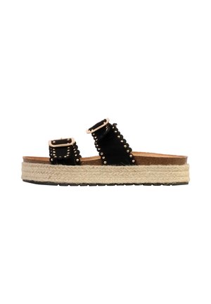 Black platform slide sandal with two studded straps and woven jute sole against white background.
