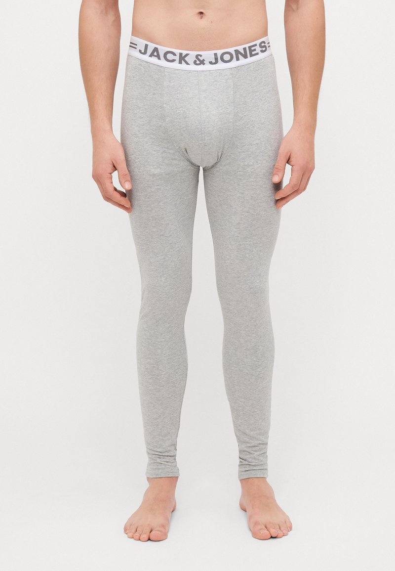 Vaaleansiniset legginsit, jotka on valmistettu sileästä ja joustavasta kankaasta. Vyötäröllä valkoinen vyötärönauha, johon on brodeerattu brändin nimi "JACK & JONES" mustilla kirjaimilla.