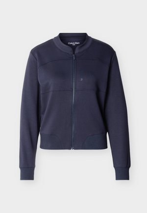 Veste zippée bleu marine avec poignets et ourlet côtelés, col sans col et logo subtil Calvin Klein Golf à l'intérieur du col.