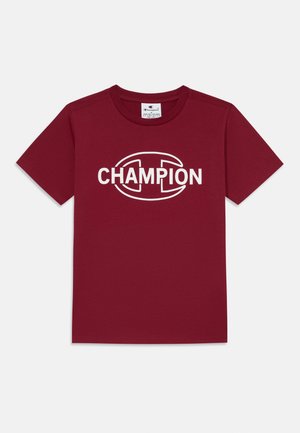 Mørkebrun bomull T-skjorte med korte ermer og rund hals. Har en stor hvit "CHAMPION" logo sentrert på forsiden.