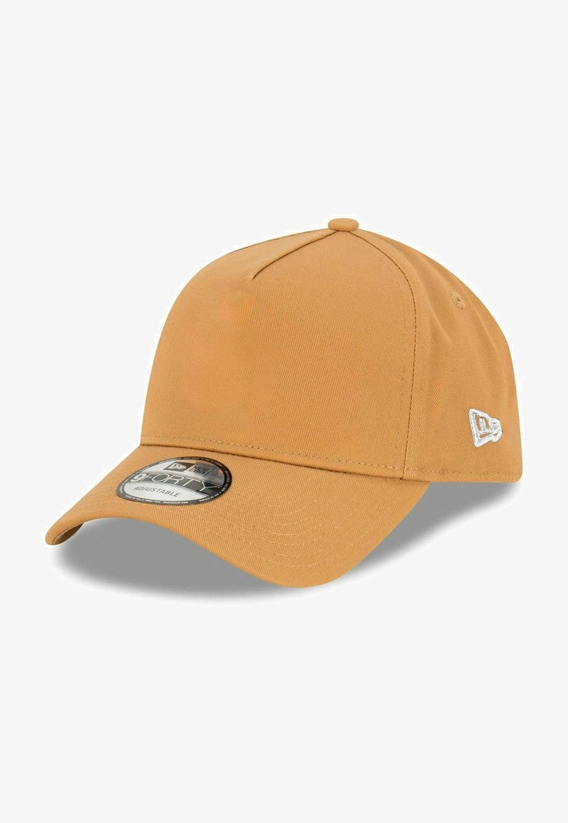 Adjustable cap in a mustard yellow color, made from textured fabric, with a curved brim and a logo patch on the side.