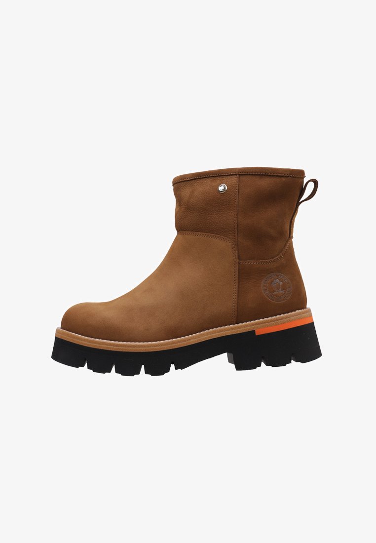 Brown suede ankle boot with a rounded toe, black chunky sole, and orange accent on the heel. Features a side logo and pull tab for ease.