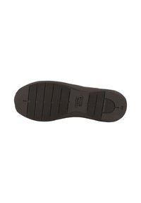 Black rubber shoe outsole featuring a textured pattern for grip, with raised lines and curves, and a logo marking "camel active."