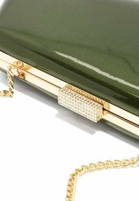Green glossy clutch with gold chain strap and a rectangular gold clasp adorned with small clear rhinestones.
