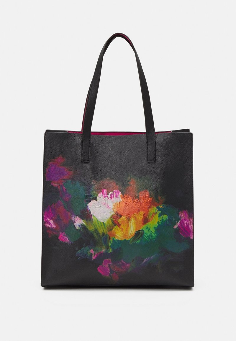 Sac fourre-tout noir avec longues anses et motif floral abstrait coloré à l'avant.