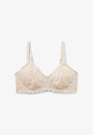 Kanten beha in zacht beige met golvende randen, verstelbare banden en bloemmotief. Beschikt over een klein strikje in het midden.