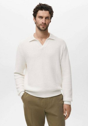 Lightweight, white knit pullover with a V-neck and collar. Features long sleeves and a textured pattern. Paired with beige trousers.