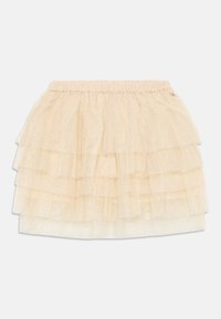 Beige lagd tulle-skjørt med elastisk linning og subtil glitterdetalj, designet for barn.