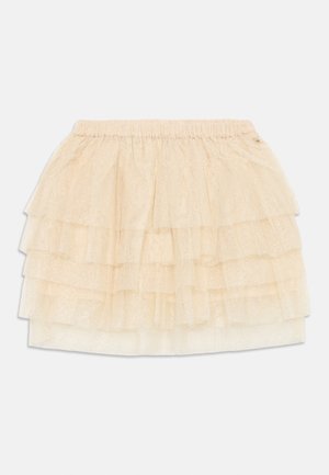 Jupe en tulle beige à plusieurs couches avec une taille élastique et des détails pailletés subtils, conçue pour un enfant.