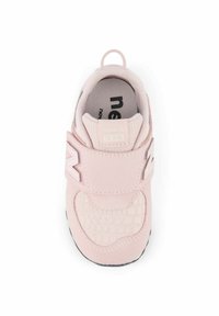 Light pink sneaker featuring a textured reptile pattern, reinforced toe, Velcro strap, and black rubber sole. Branding on tongue and side.