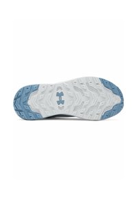 Traction sole of a sneaker with white rubber base, textured surface, and light blue accents; features a unique pattern for grip.