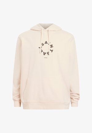 Lichtbeige hoodie met een voorzak, capuchon met koord en een cirkelvormig bruin logo met de tekst "SAINT" en "LONDON" in het midden.