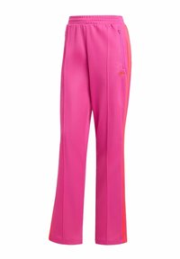 Roze trackpants van zachte stof, met een elastische tailleband, een zijzak met ritssluiting en oranje strepen aan de zijkanten.