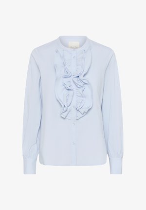 Hele sinine pika varrukaga pluus nupuga ees ja vertikaalse volangi detailiga nupukaitse ääres.