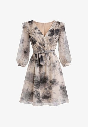 Vestito beige fino al ginocchio con stampa floreale nera, scollo a V, maniche lunghe trasparenti a sbuffo, dettagli con volant sulle spalle e cintura annodata in vita.