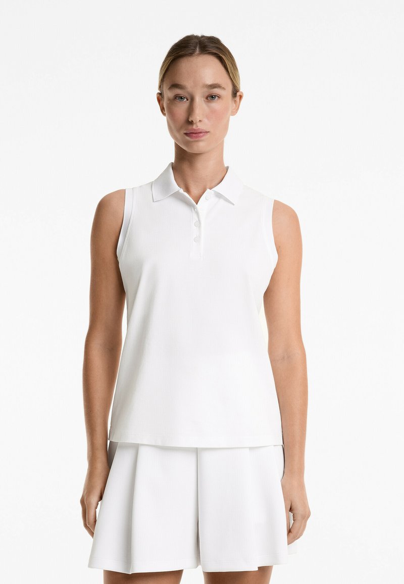 White sleeveless polo shirt with a collared neckline and three buttons. Paired with matching white pleated shorts, featuring a smooth texture.
