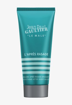 Jean Paul Gaultier Le Male soothing after shave balm in a teal tube with silver cap and horizontal stripes.