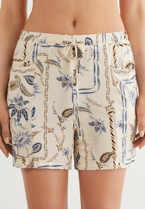 Ljust beige shorts med ett blommigt mönster i blått och brunt, med två sidofickor och en elastisk midja med dragsko.