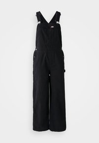 Salopette noire en coton avec poche poitrine à l’avant, bretelles réglables, boutons latéraux et jambes larges et droites.