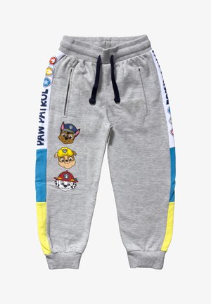 Pantalon de survêtement gris avec ceinture élastique et cordon de serrage bleu marine. Présente des personnages imprimés de la Pat' Patrouille et des panneaux latéraux colorés en bleu et jaune.