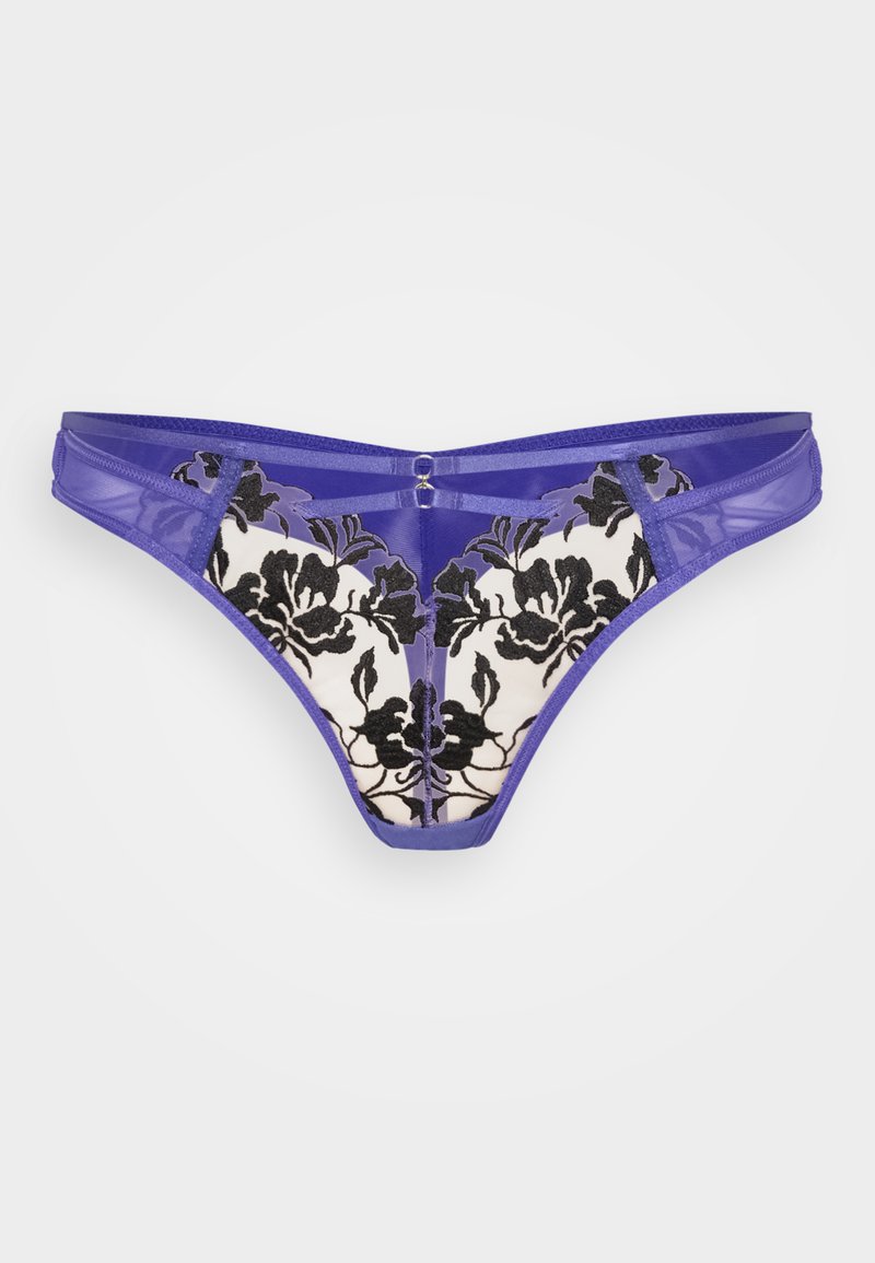 String violet en dentelle avec broderie florale noire sur fond crème, présentant des découpes et un petit accent métallique au centre.