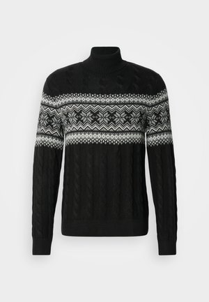 Juodas megztas golfas su pintu raštu ir baltu geometriniu snaigių raštu krūtinės srityje. Ilgos rankovės, ribintos rankogaliai ir apačia.