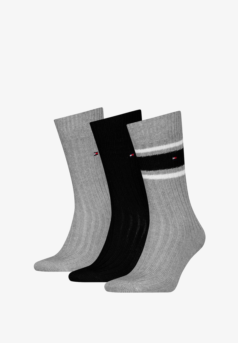 Three pairs of crew socks in gray, black, and light gray. Ribbed texture, contrasting stripe design, and small logo on the side.