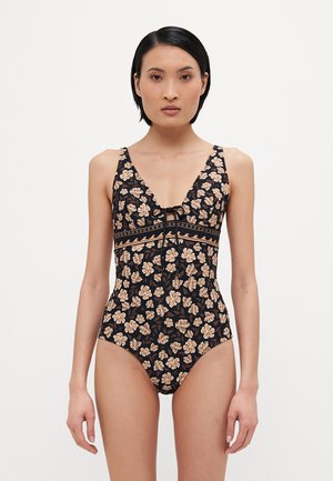 Maillot de bain une pièce noir avec un motif floral en beige et marron. Il présente un décolleté en V et un lien ajustable à l'avant.