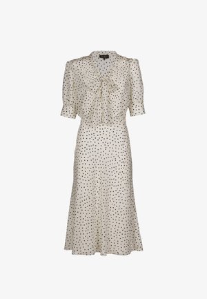 Abito a pois crema con puntini neri, caratterizzato da maniche corte a sbuffo, scollo con fiocco e gonna fluente di media lunghezza.