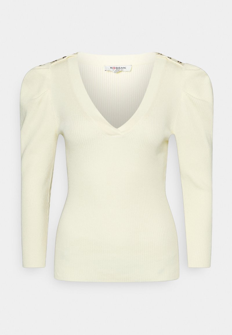 Pull en maille côtelée crème avec un col en V, des épaules bouffantes, des manches longues et des boutons dorés sur les coutures des épaules.