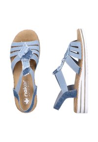 Blue fabric sandals with multiple straps, frayed accents, and a cushioned footbed. Features a white sole with subtle stripes and a rounded design.