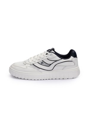 White low-top sneaker with thick sole, black interior lining, black wave-like stripes on the side, and white laces.