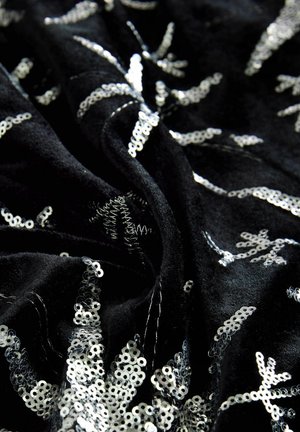 Melna samta auduma, ar sudraba izšūtu ziedu rakstu, parādot krokas un detalizētu tekstūru.