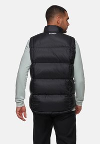 Schwarze Daunenweste mit hohem Kragen und gesteppten Panels. Das Material wirkt glänzend und isolierend, entworfen für Wärme und Funktionalität.