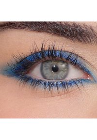 Närbild på ett öga med grågrön iris, mörka fransar och djärvt blå eyeliner. Huden runt ögat är slät med en mjuk textur.