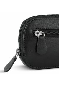 Black leather zippered pouch with textured finish, featuring a silver hardware zipper and a rounded shape. Compact design with smooth accents.