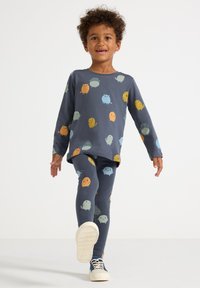 Bambus-pyjamasæt til børn i mørkeblå med legesyge pastelfarvede monster mønstre, bestående af en langærmet top og matchende leggings.