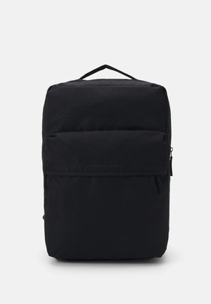 Schwarzer rechteckiger Rucksack mit einer vorderen Reißverschlusstasche und einem kleinen oberen Griff, vor einem einfachen hellen Hintergrund dargestellt.