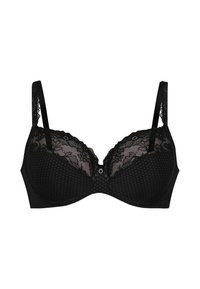 Reggiseno in pizzo nero con motivo a pois, coppe sagomate, spalline regolabili e un dettaglio decorativo al centro. Sovrapposizione di pizzo morbido nella parte superiore.