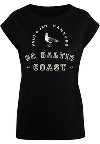 Black t-shirt featuring a white seagull graphic, text reading "GO BALTIC COAST 2023," and contrasting beige accents in a casual design.