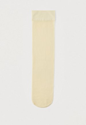 Κάλτσες μέχρι το γόνατο σε ανοιχτό μπεζ, με ριμπ υφή, ομαλή επιφάνεια, στρογγυλεμένη μύτη και ταιριαστό μανσέτα στην κορυφή.